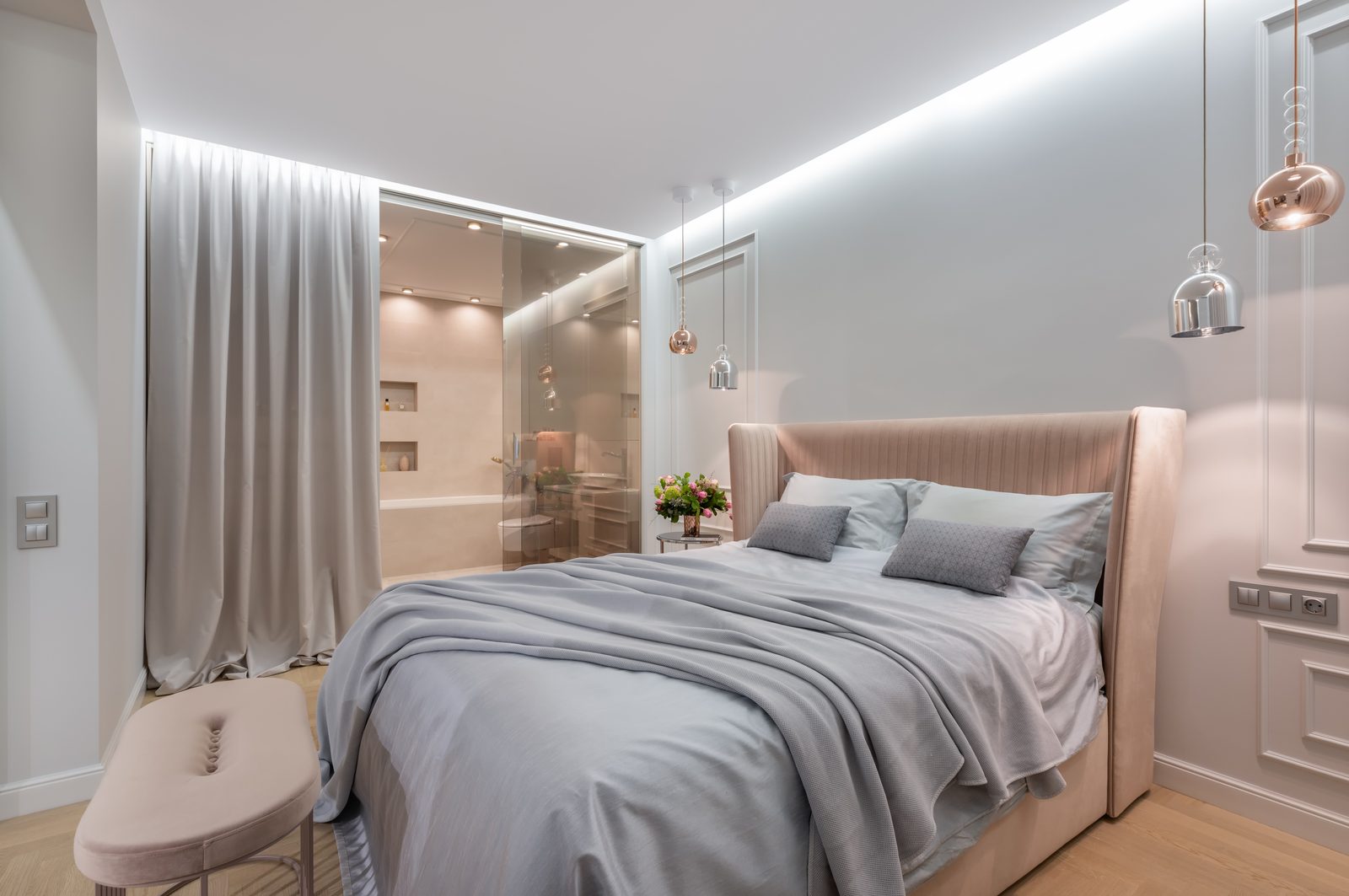 Warm bedroom design with ambient lighting at Raheja Reserve by Viona Interiors